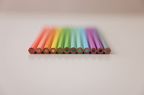 Unsharpened Colored Pencils on a White Surface