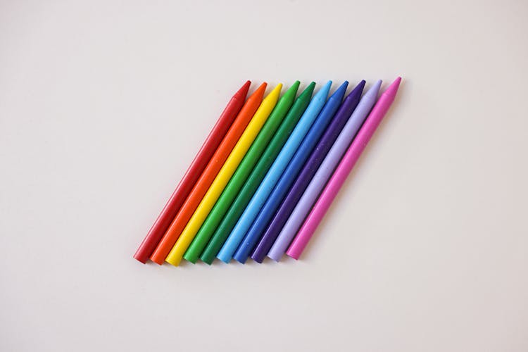 Row Of Crayons On A White Surface