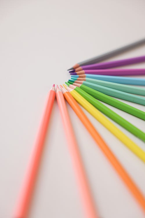 Set of Sharpened Colored Pencils on a White Surface