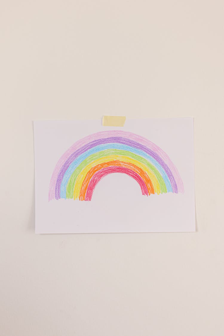 Artwork With Rainbow Drawing Posted On A Wall