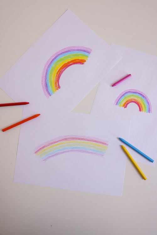 Free Vibrant rainbow drawings made with colored pencils on white paper. Stock Photo