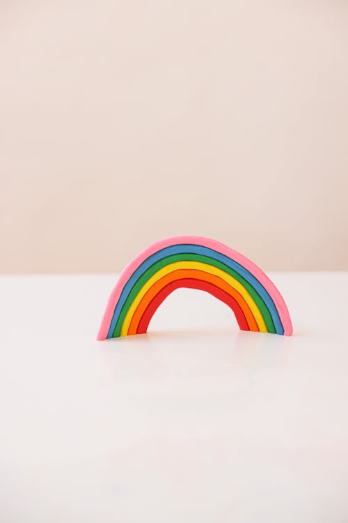 A Rainbow Made of Colorful Clay on a White Surface