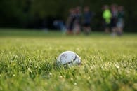 White Soccer Ball on Green Grass Field