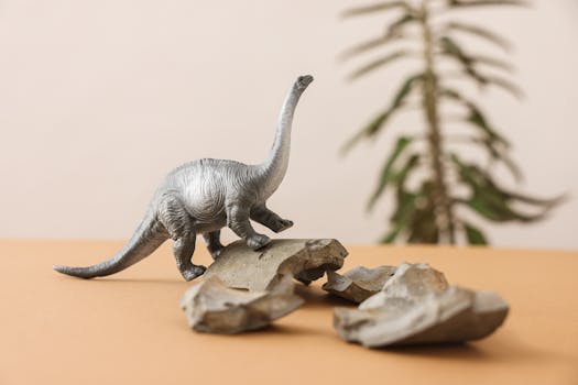 A realistic dinosaur figurine set amidst rocks, ideal for educational and creative purposes.