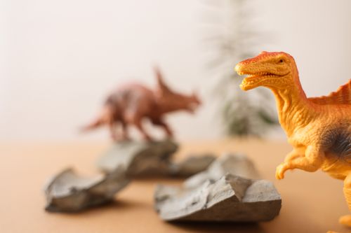 Free Close-up of dinosaur toys on rocks, showcasing vibrant colors and a playful setup. Stock Photo