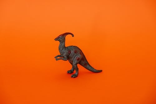 Dinosaur Figurine against Orange Background