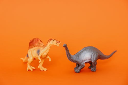 Free Grey and Orange Toy Dinosaurs  Stock Photo