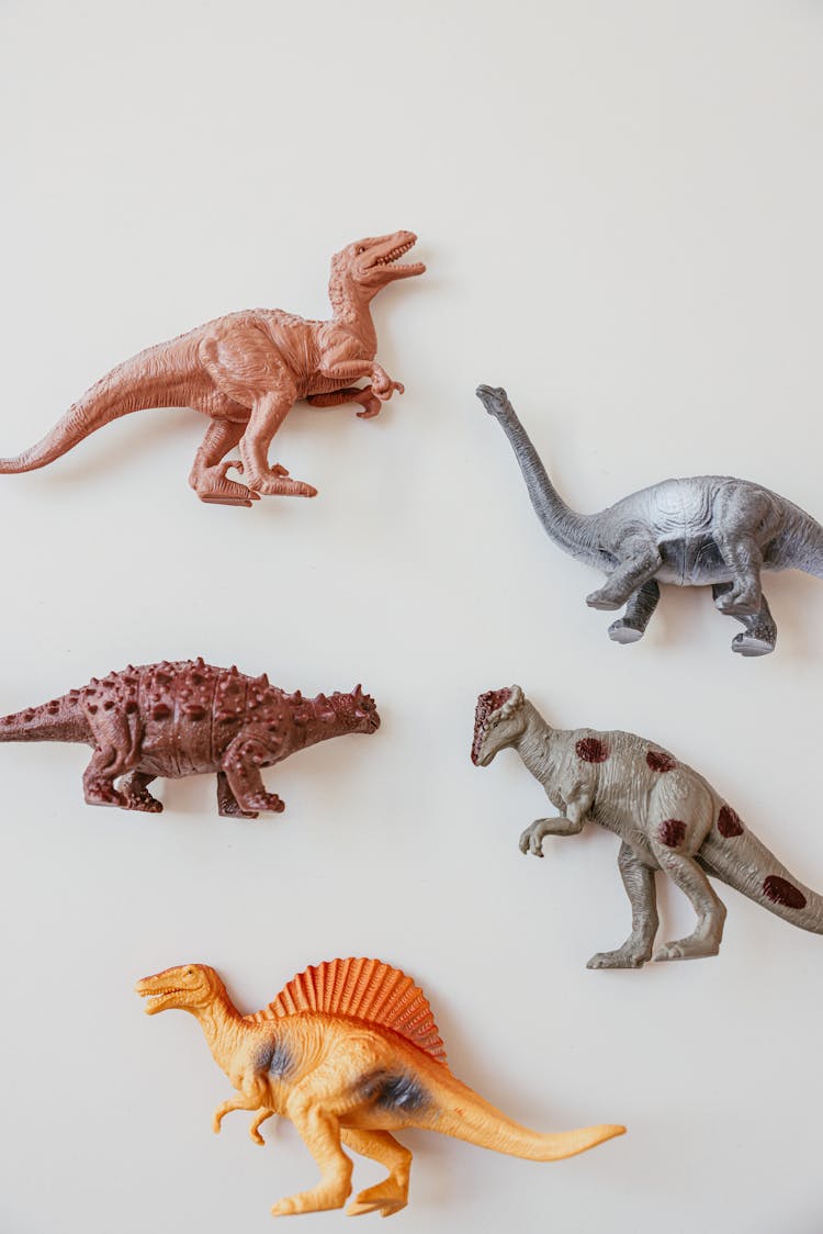 Plastic Dinosaur Toys Over White Surface