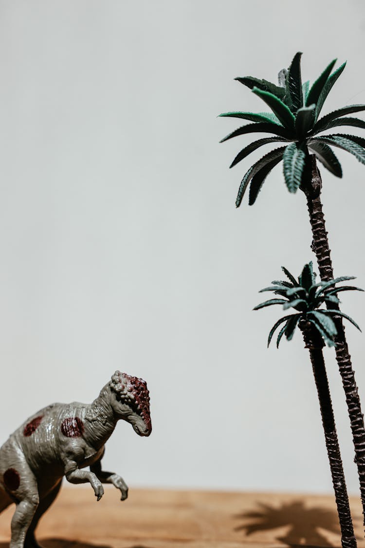 Plastic Dinosaur And Palm Trees Figurines