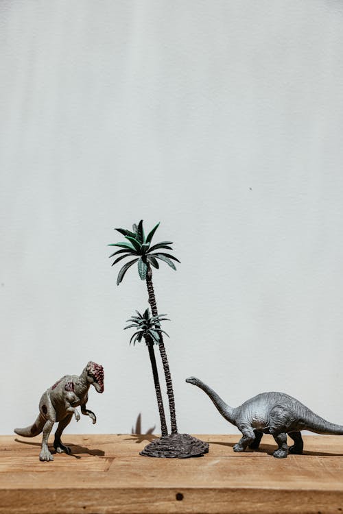 Mini Dinosaurs Near Miniature Palm Tree