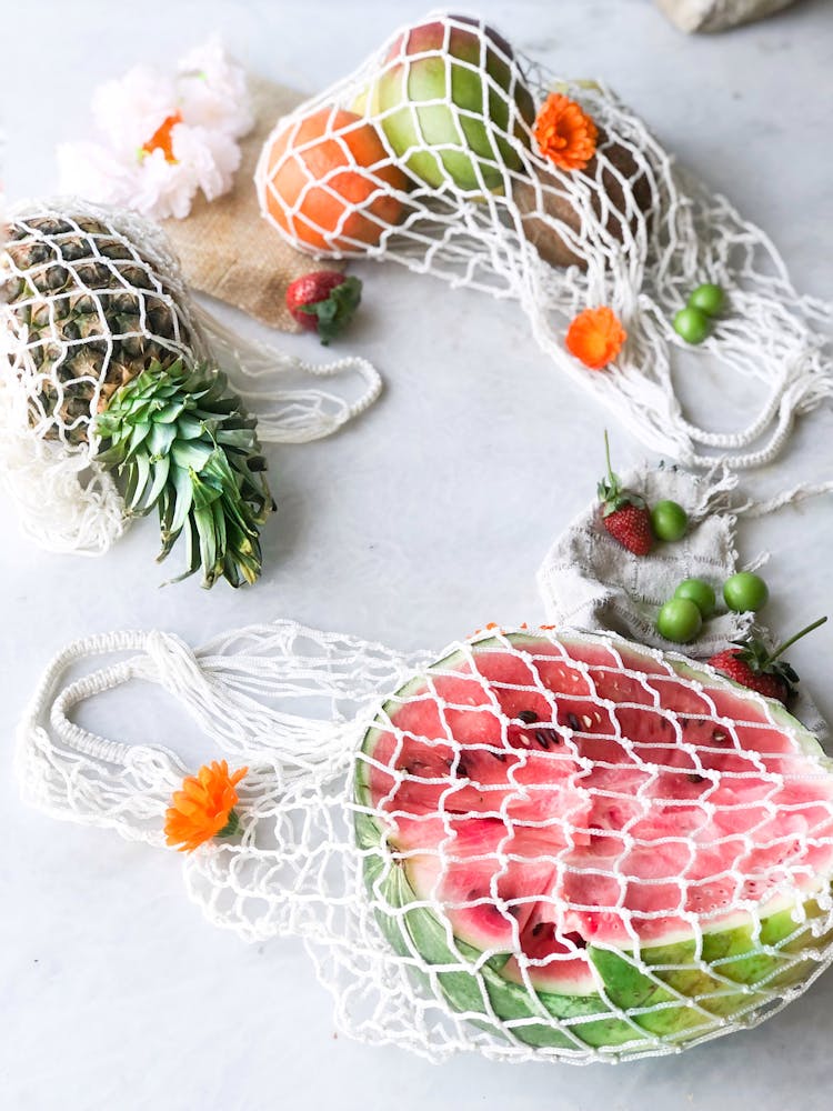 Top View Of Fruits In White Net Bags