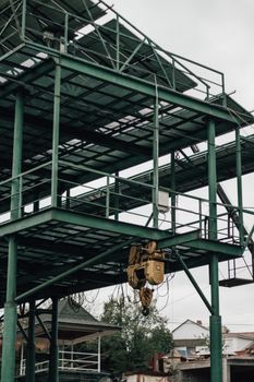 Steel structure under construction with visible hoist winch and scaffolding.