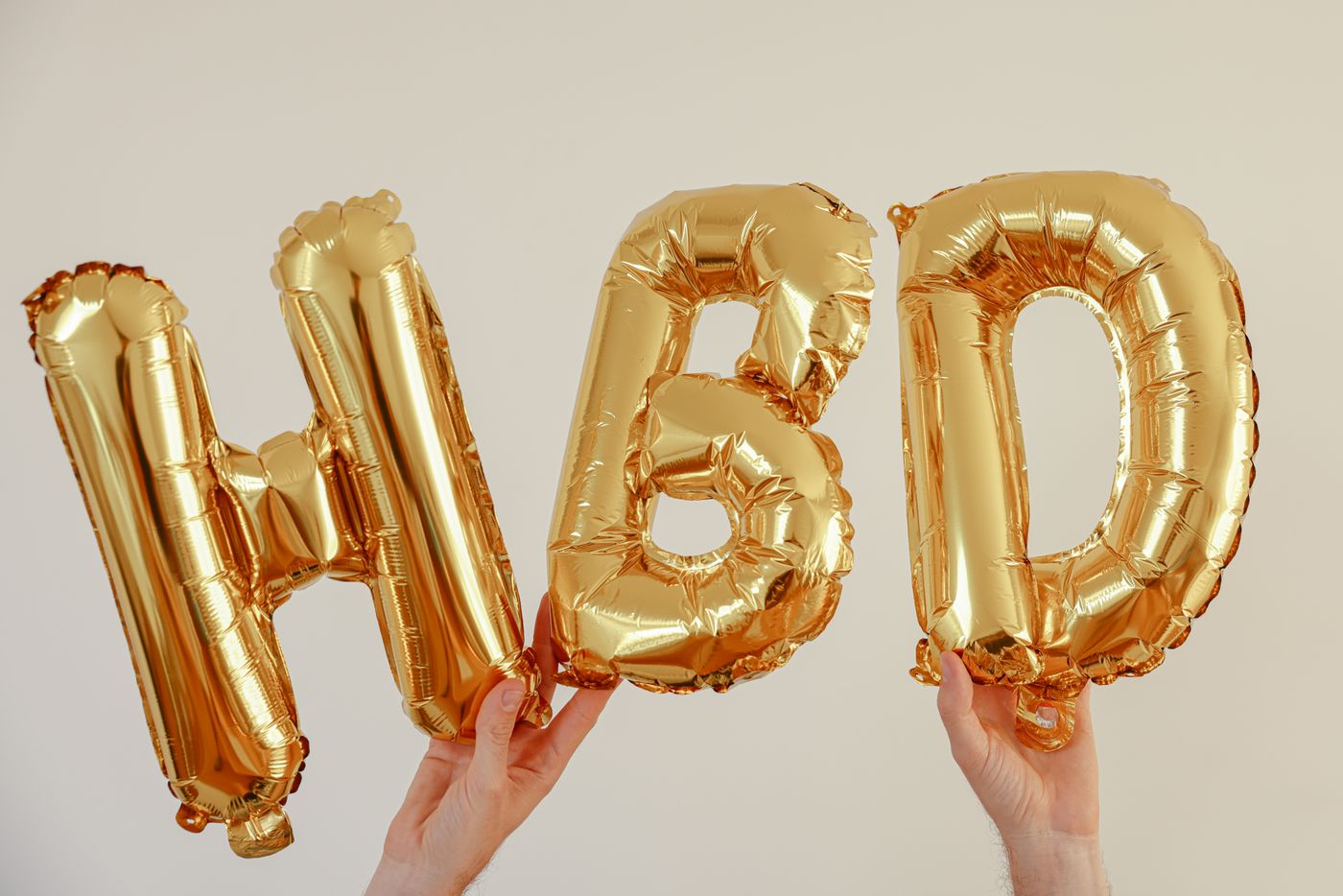 Gold letter balloons spelling a birthday message