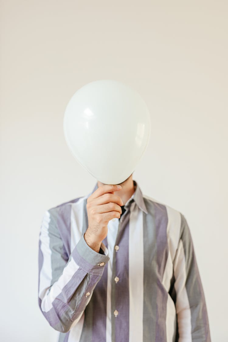 A Man's Face Covered With White Balloon