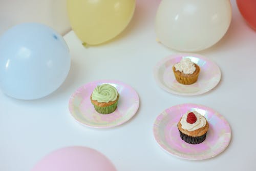 Free Delicious Cupcakes on a Tables with Balloons Stock Photo