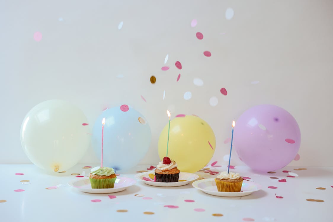 Free A Cupcakes on the Table with Lighted Candles and Balloons Stock Photo