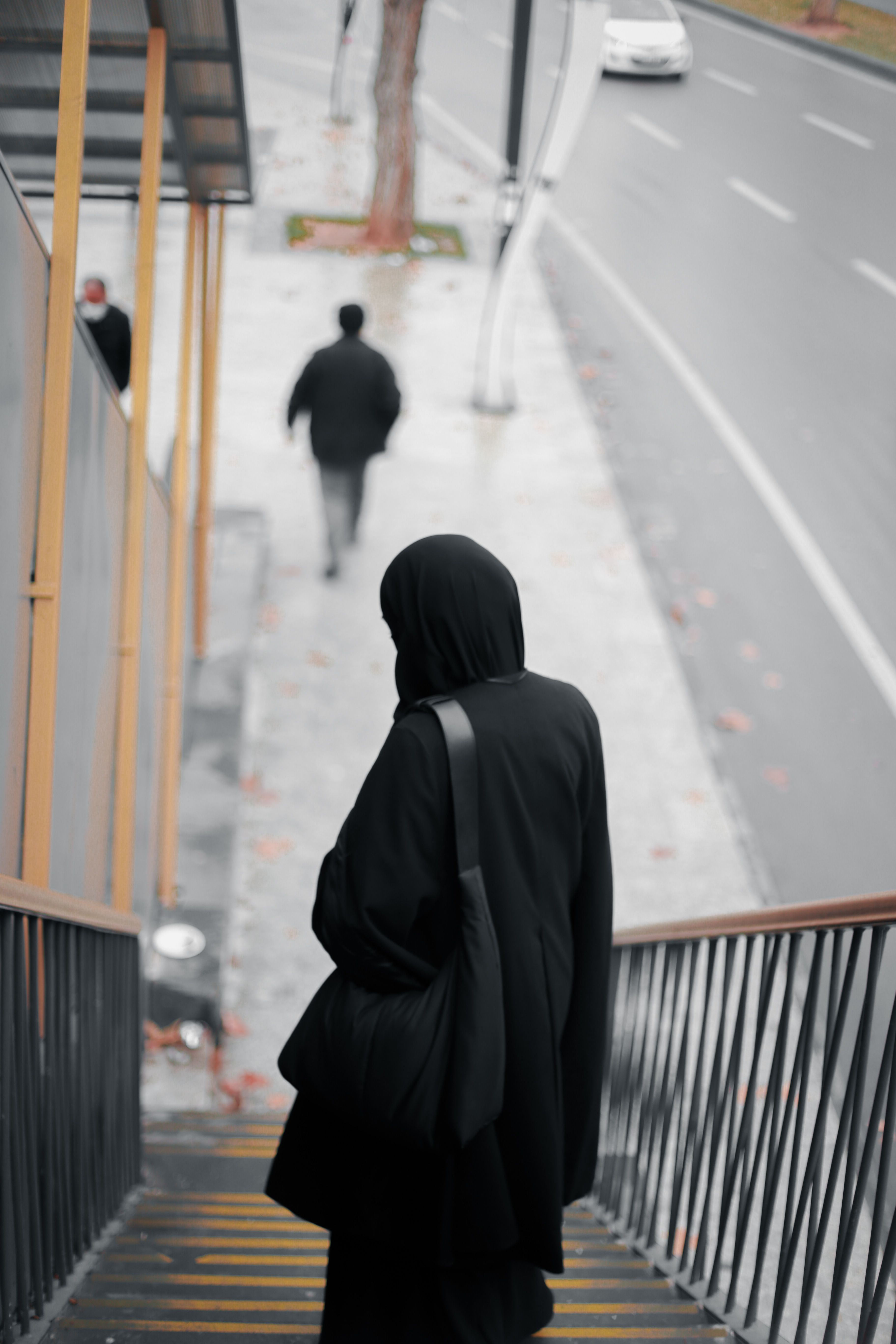 Back View of a Person Wearing Black Clothes Standing on The Stairs ...