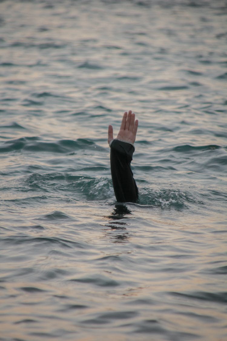 Hand Of A Person Drowning In The Ocean