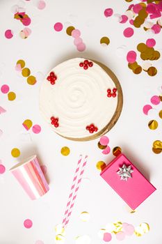 Top view of birthday cake with decorations and gift, ideal for celebration themes.