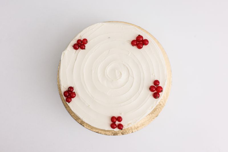 Minimal white layered wedding cake with fresh seasonal flowers