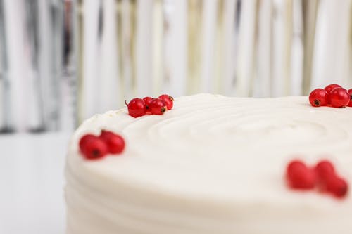 Close-Up Shot of a Delicious Birthday Cake with Red Cherries on Top