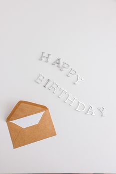 Simple birthday scene with envelope and letters spelling 'Happy Birthday'.