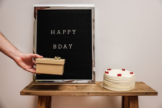 Celebrate a birthday with a cake, gift and Happy Bday letter board.