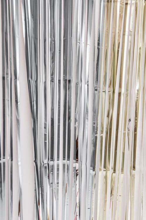 Free Stylish vertical silver and gold foil curtains create a chic decorative backdrop. Stock Photo