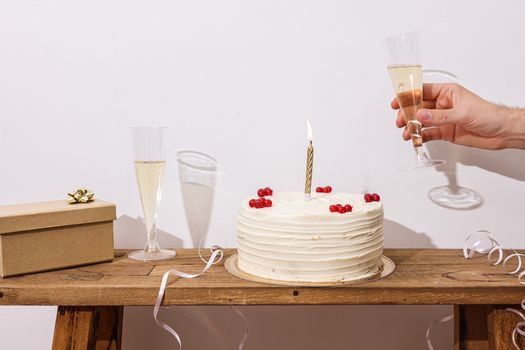 A festive scene with a cake, champagne, and a gift box perfect for celebrations.