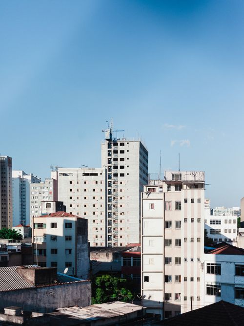 Free View of contemporary high-rise buildings against a clear blue sky. Stock Photo