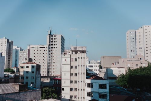 Free Contemporary cityscape featuring modern apartment buildings under a clear blue sky. Stock Photo