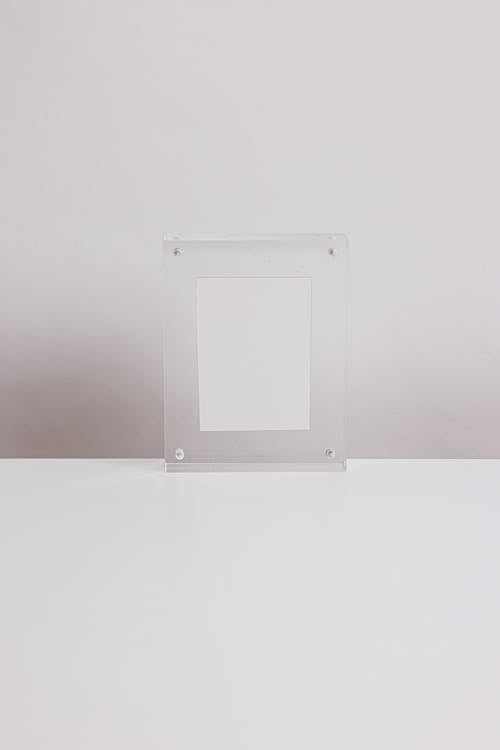 A Translucent Empty Frame on a White Surface