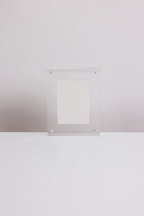 A Translucent Empty Frame on a White Surface · Free Stock Photo