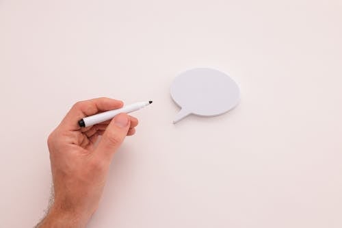 A Person Holding a Marker next to a Thought Bubble