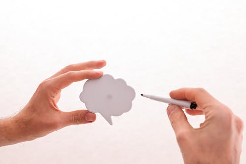 A Person Holding a Marker and a Thought Bubble