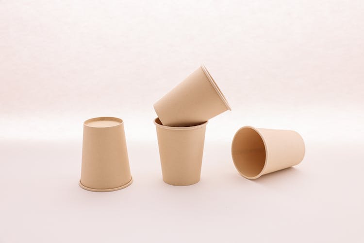 A Mockup Of Disposable Cups On A White Surface