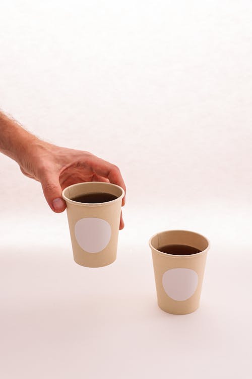 Photo gratuite de café, gobelets en papier, gobelets jetables, main,  maquette, tir vertical