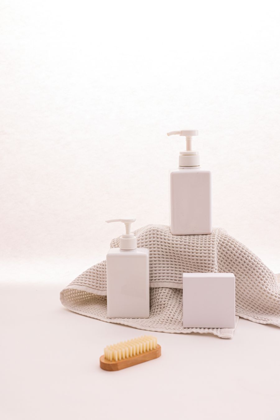 White pump bottles with a wooden brush