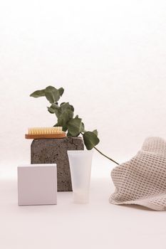 Elegant studio shot of skincare products with natural leaf and textured fabric for organic theme.