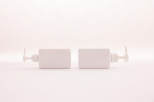 Simple and elegant white pump bottles on a clean white background, perfect for beauty product mockups.