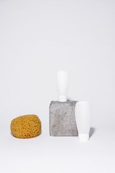 Minimalist setup with a loofah and squeeze bottles for bathroom products.