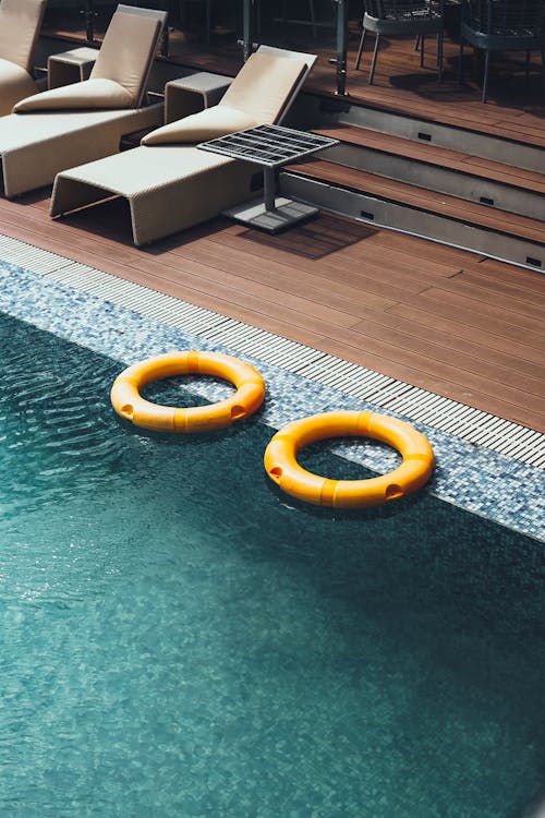 Free A Pair of Yellow Floaters on a Swimming Pool Stock Photo