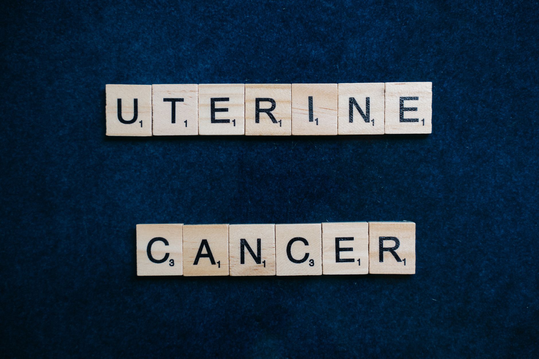 fenbendazole dosing for colon cancer — Scrabble tiles spelling 'uterine cancer' on a dark blue background, symbolizing awareness.