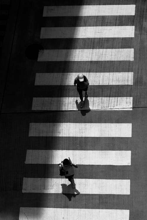Free Monochrome Shot of People Walking on a Pedestrian Lane Stock Photo