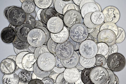 A detailed collection of various US coins including quarters, nickels, and dimes.