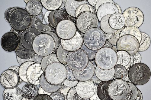 Free A detailed collection of various US coins including quarters, nickels, and dimes. Stock Photo