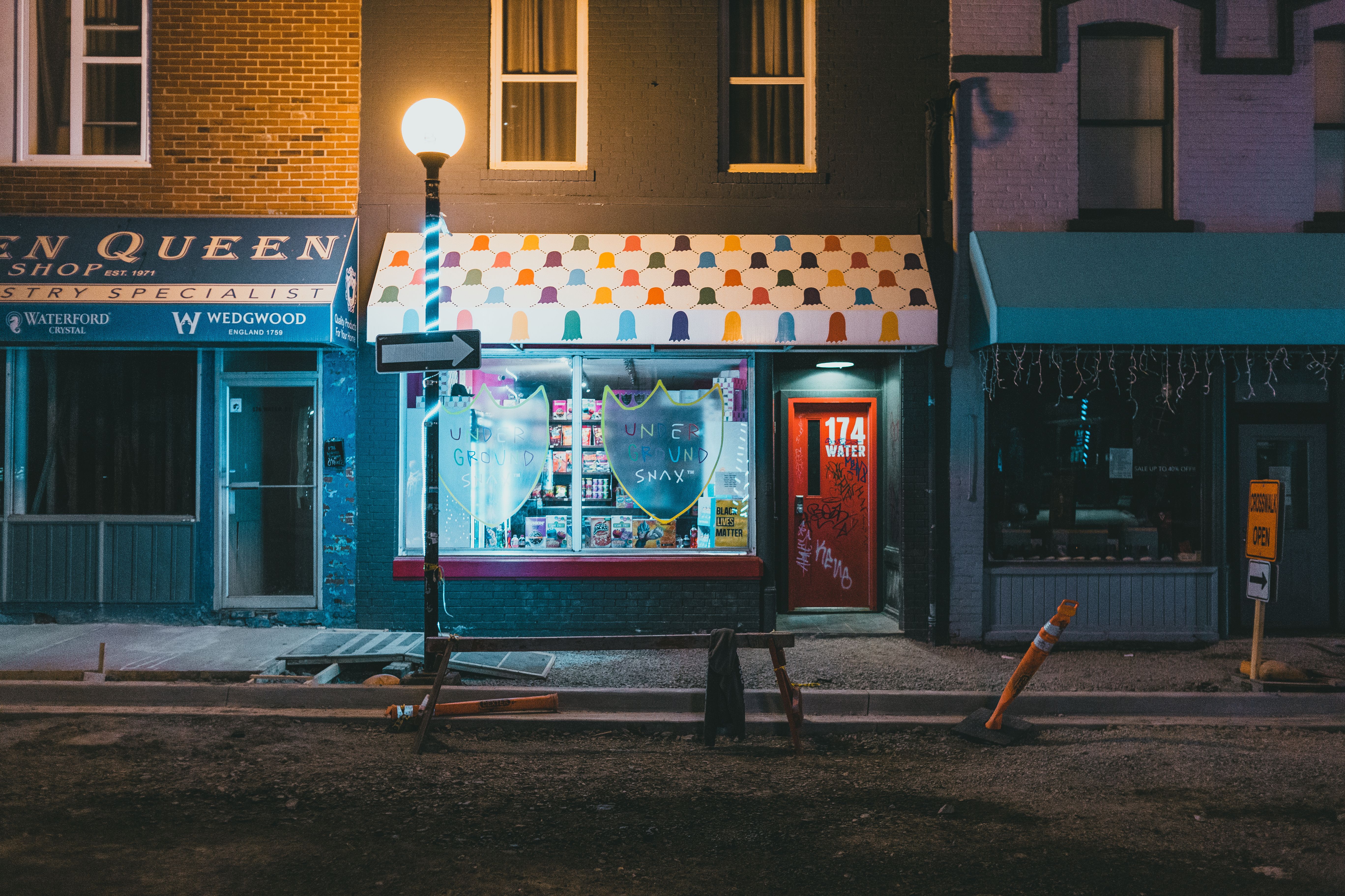 Illuminating Lamp Post near Stores · Free Stock Photo