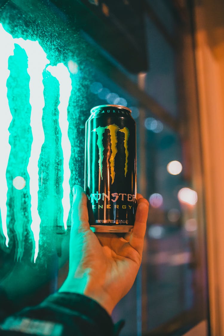 Man Holding A Can Of Energy Drink 