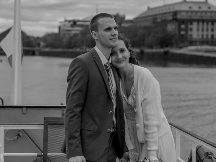 Romantic Newlywed Couple Floating On Boat On River