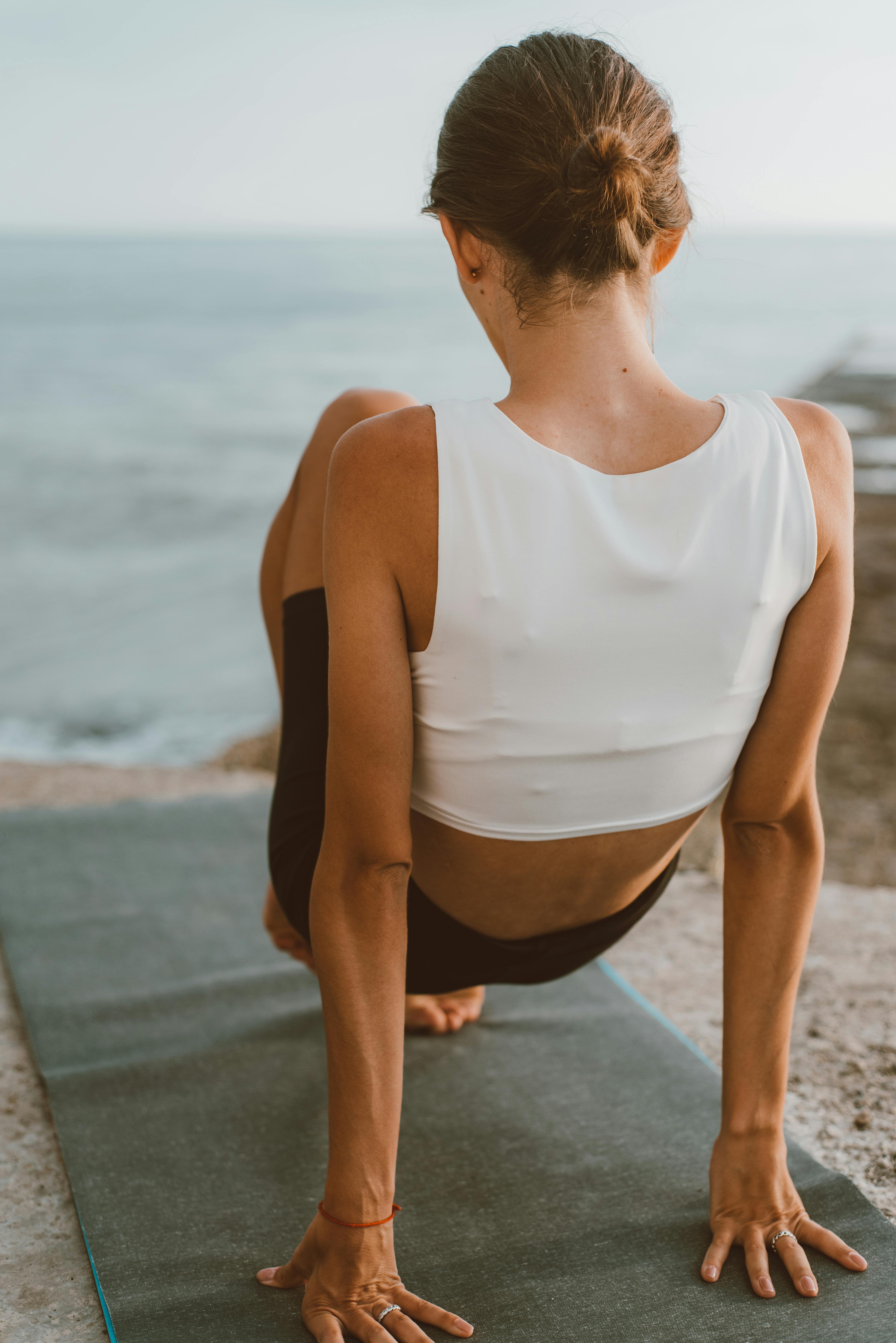 back view of a person working out near the sea